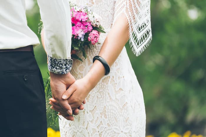 The gentle details of a wedding day: two hands held together